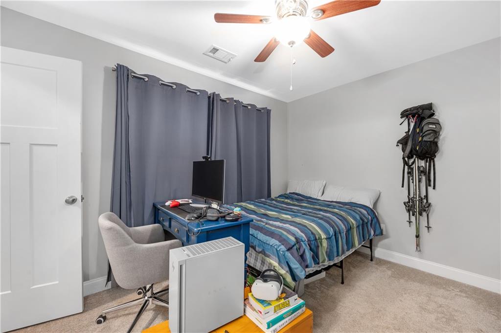 39 Floating Leaf Way Dallas, GA 30132 - Photo 30 of 40 a bedroom with a bed and a chandelier