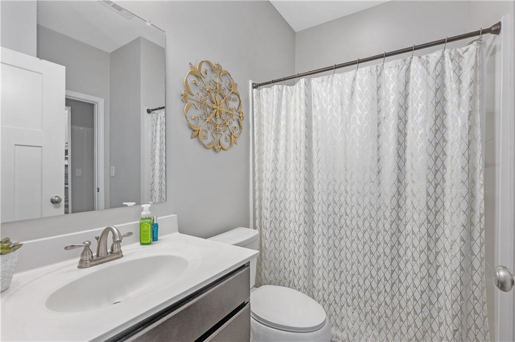 39 Floating Leaf Way Dallas, GA 30132 - Photo 33 of 40 a bathroom with a sink a toilet and shower curtain