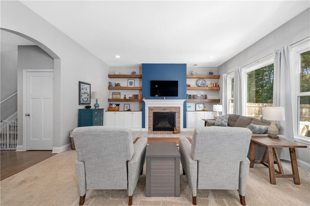 39 Floating Leaf Way Dallas, GA 30132 - Photo 10 of 40 a living room with furniture a fireplace and a flat screen tv