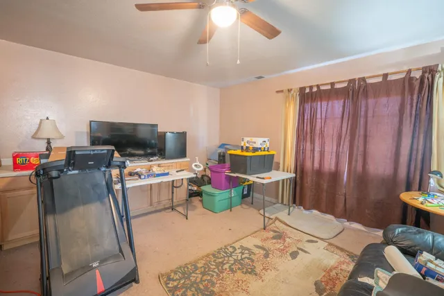 a view of a workspace with furniture and a fireplace