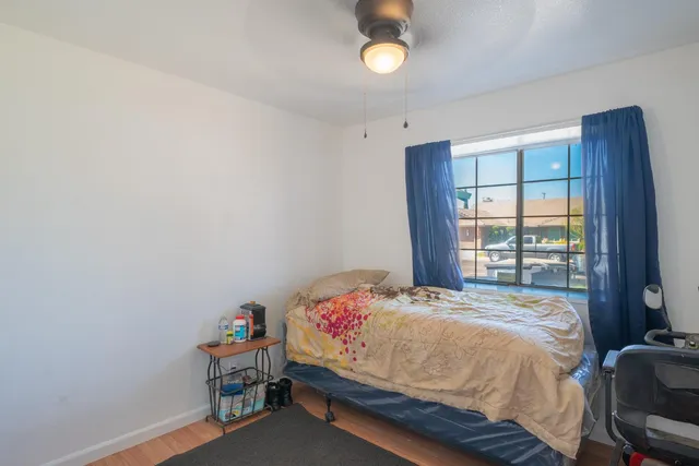 a view of backyard with wheel chair potted plants and large tree