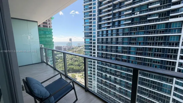 a view of a balcony with a floor to ceiling window and wooden floor