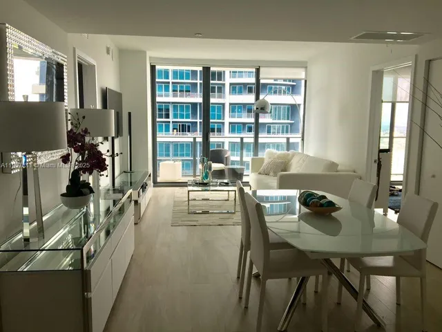 a dining room with furniture and window