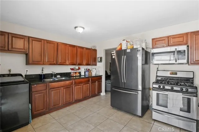 a kitchen with granite countertop stainless steel appliances and wooden cabinets