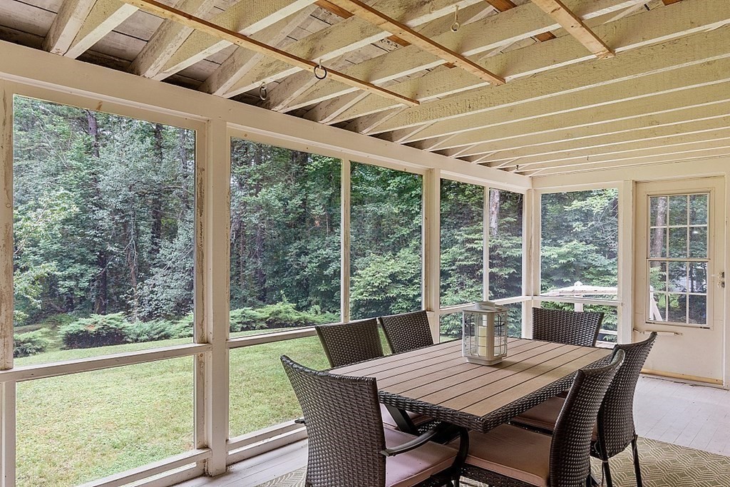 100 Chester Road Boxborough, MA 01719 - Photo 24 of 40 a view of a dining room with furniture large windows and wooden floor