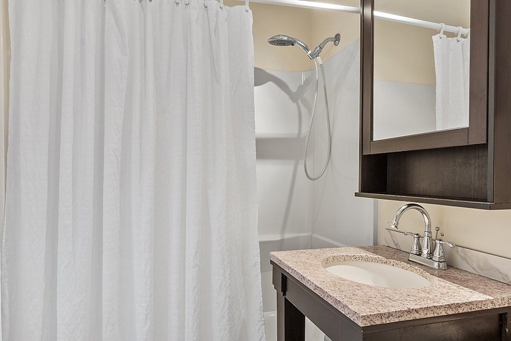 100 Chester Road Boxborough, MA 01719 - Photo 36 of 40 a bathroom with a granite countertop sink and a mirror