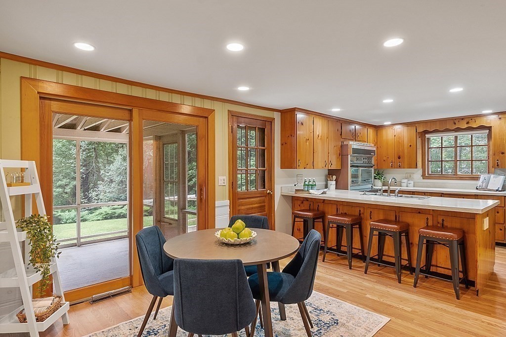 100 Chester Road Boxborough, MA 01719 - Photo 8 of 40 a dining room with stainless steel appliances granite countertop a table and chairs
