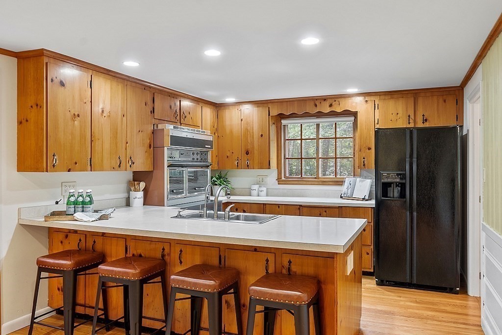 100 Chester Road Boxborough, MA 01719 - Photo 9 of 40 a kitchen with a refrigerator a sink dishwasher and wooden cabinets with wooden floor