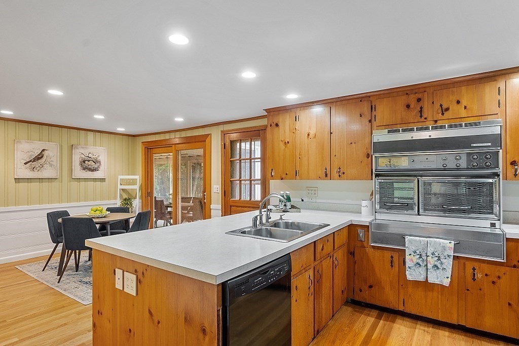 100 Chester Road Boxborough, MA 01719 - Photo 10 of 40 a kitchen with a stove a sink a dining table and chairs