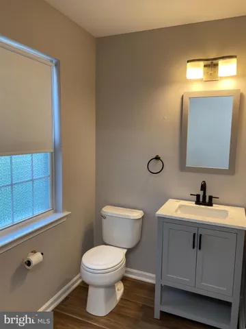 a bathroom with a toilet sink and mirror