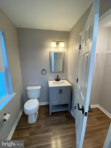 a bathroom with a sink toilet a mirror and shower