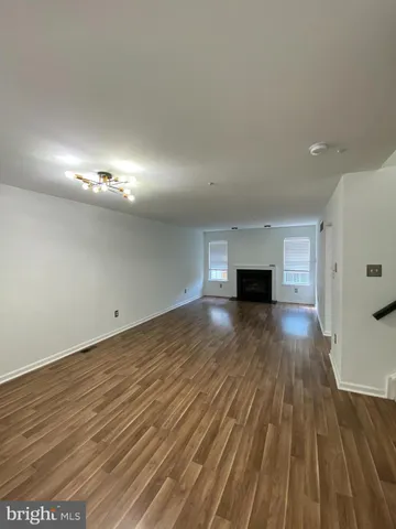 a view of a room with wooden floor and fire place