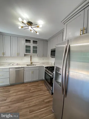 a kitchen with a refrigerator sink and cabinets