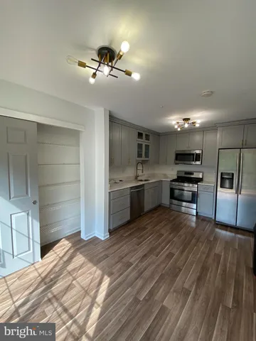 a kitchen with a refrigerator and a sink