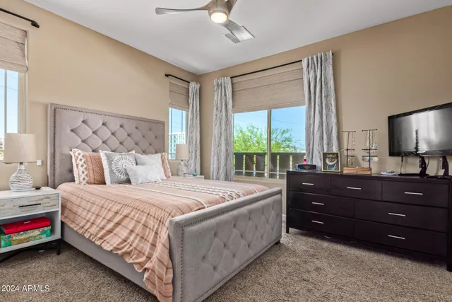 a bedroom with a bed window and a dresser