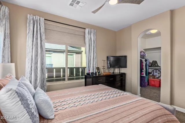 a bedroom with a bed and a television