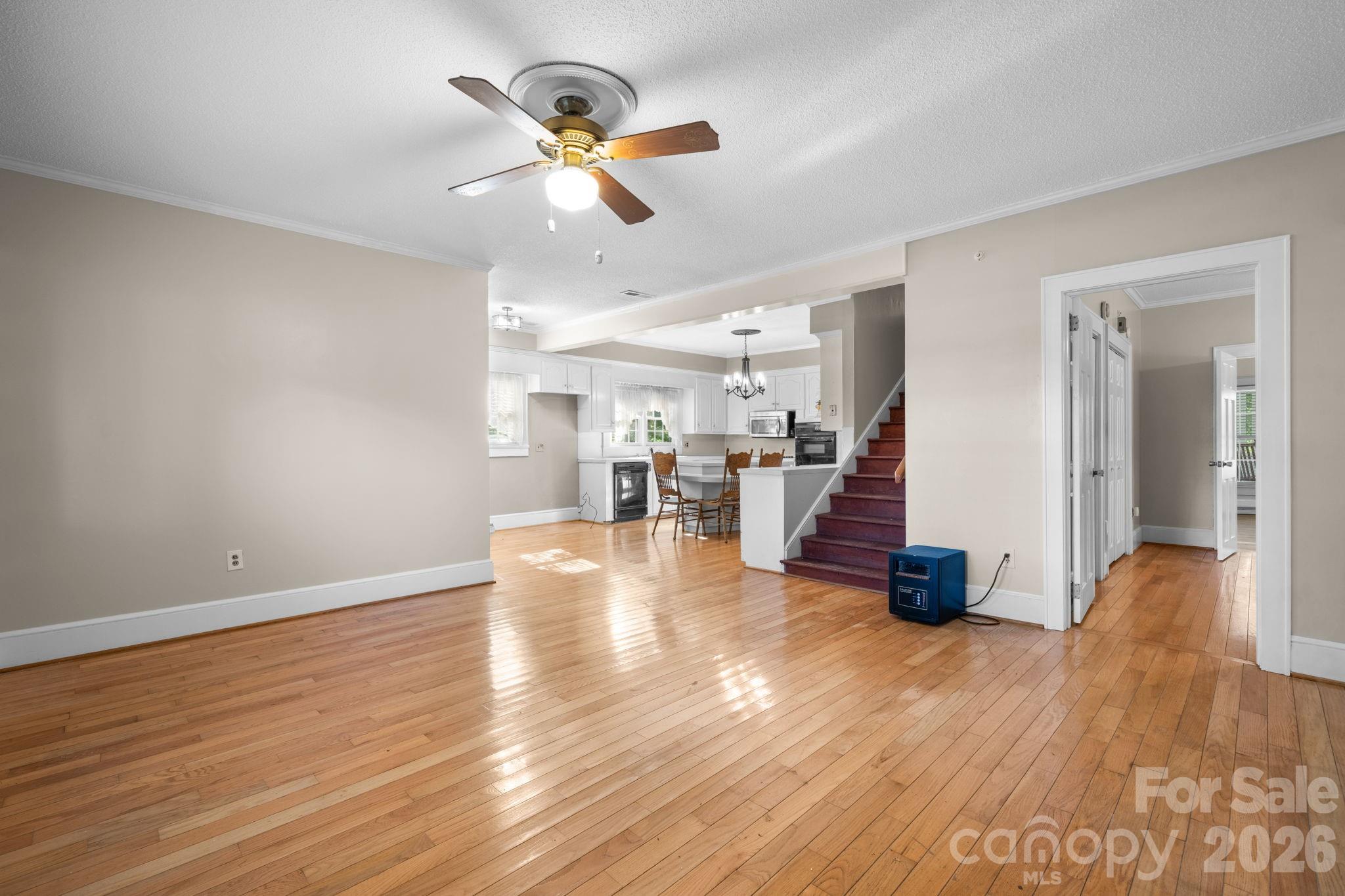 144 Hunter Bridge Road Stony Point, NC 28678 - Photo 3 of 45 a view of a livingroom with hardwood floor and a ceiling fan