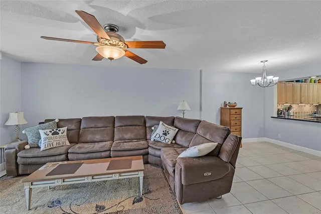 a living room with furniture and kitchen view
