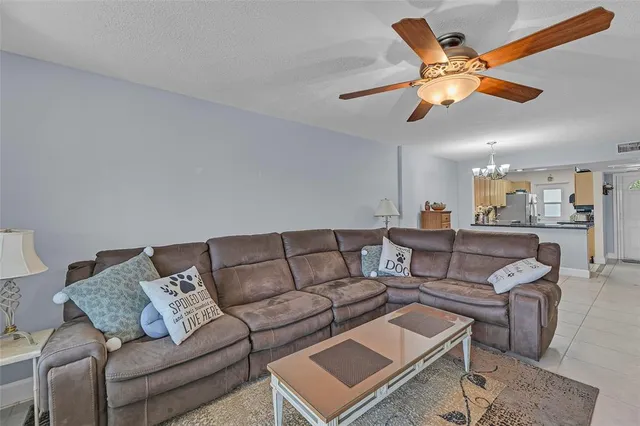 a living room with furniture and a ceiling fan