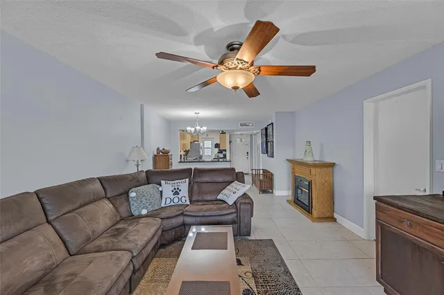 a living room with furniture a fireplace and a window