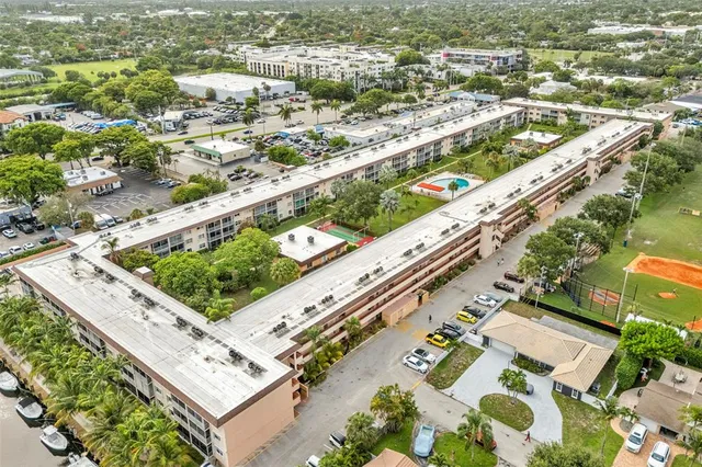 a view of a patio with table and chairs with wooden floor and fence