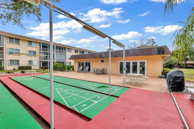 a view of a livingroom with furniture and floor to ceiling window