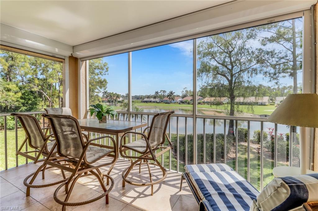 5985 Bloomfield Circle, Unit D203 Naples, FL 34112 - Photo 1 of 38 Sunroom with tile patterned floors and a water view