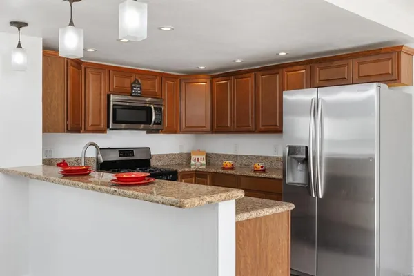 an empty room with windows and a ceiling fan