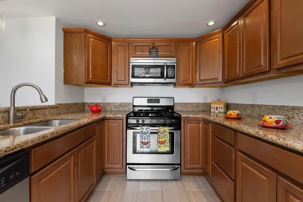 a bathroom with a granite countertop sink double vanity and a mirror