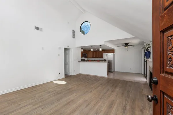 a view of a room with wooden floor and a fireplace
