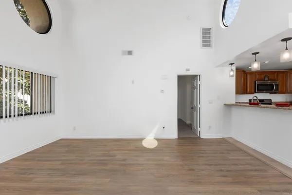 a kitchen with granite countertop a sink a stove and cabinets