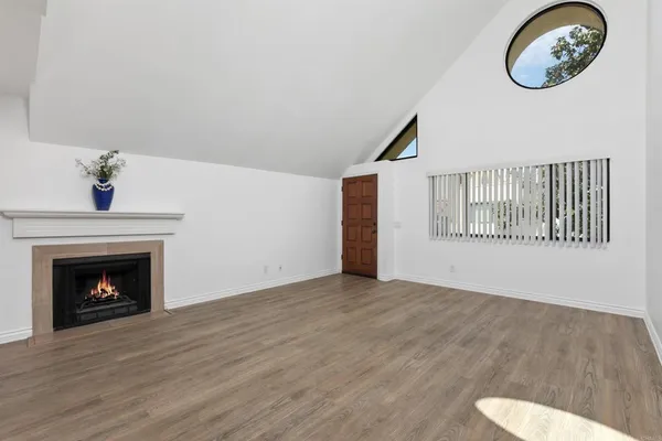 a view of a room with wooden floor and a fireplace