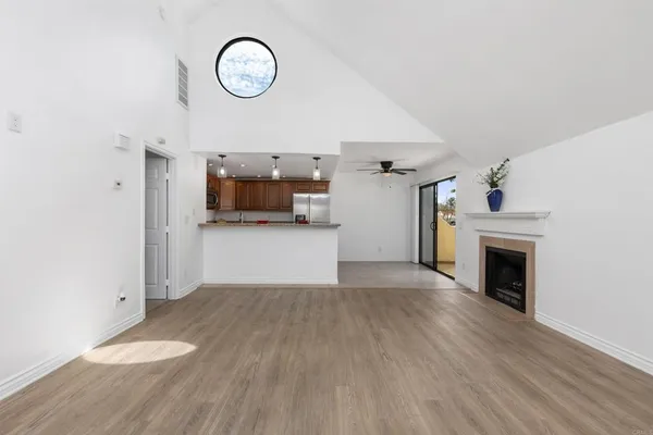 a kitchen with stainless steel appliances kitchen island granite countertop a refrigerator and a sink