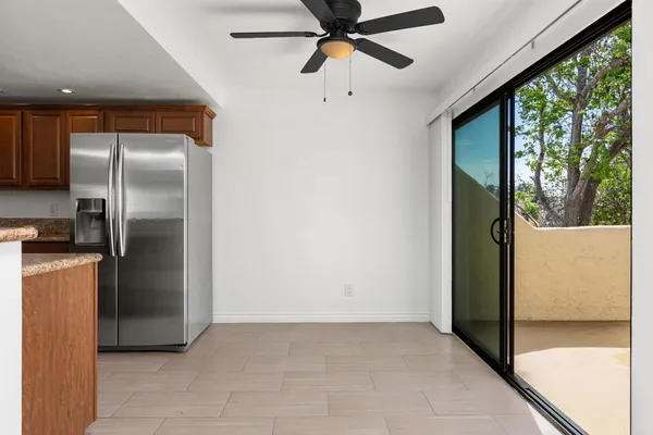 a kitchen with stainless steel appliances granite countertop a refrigerator a microwave a sink and a stove