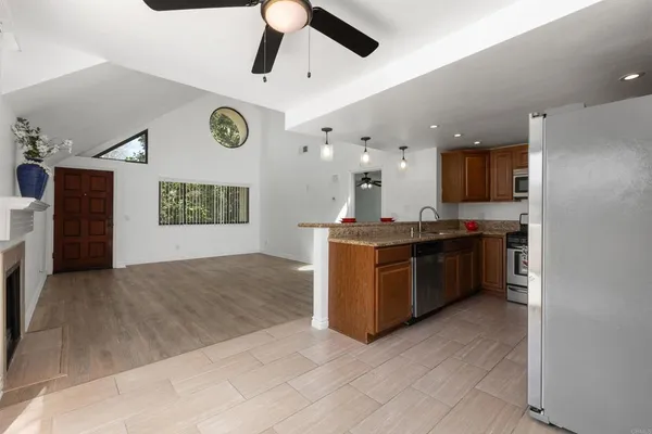 a kitchen with stainless steel appliances granite countertop a stove a sink and a microwave