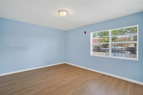 wooden floor in an empty room with a window