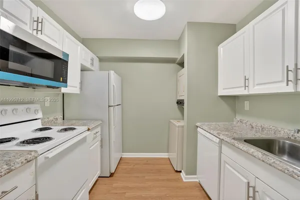 a kitchen with a sink a stove and a refrigerator