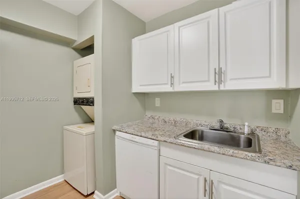 a kitchen with white cabinets and a sink