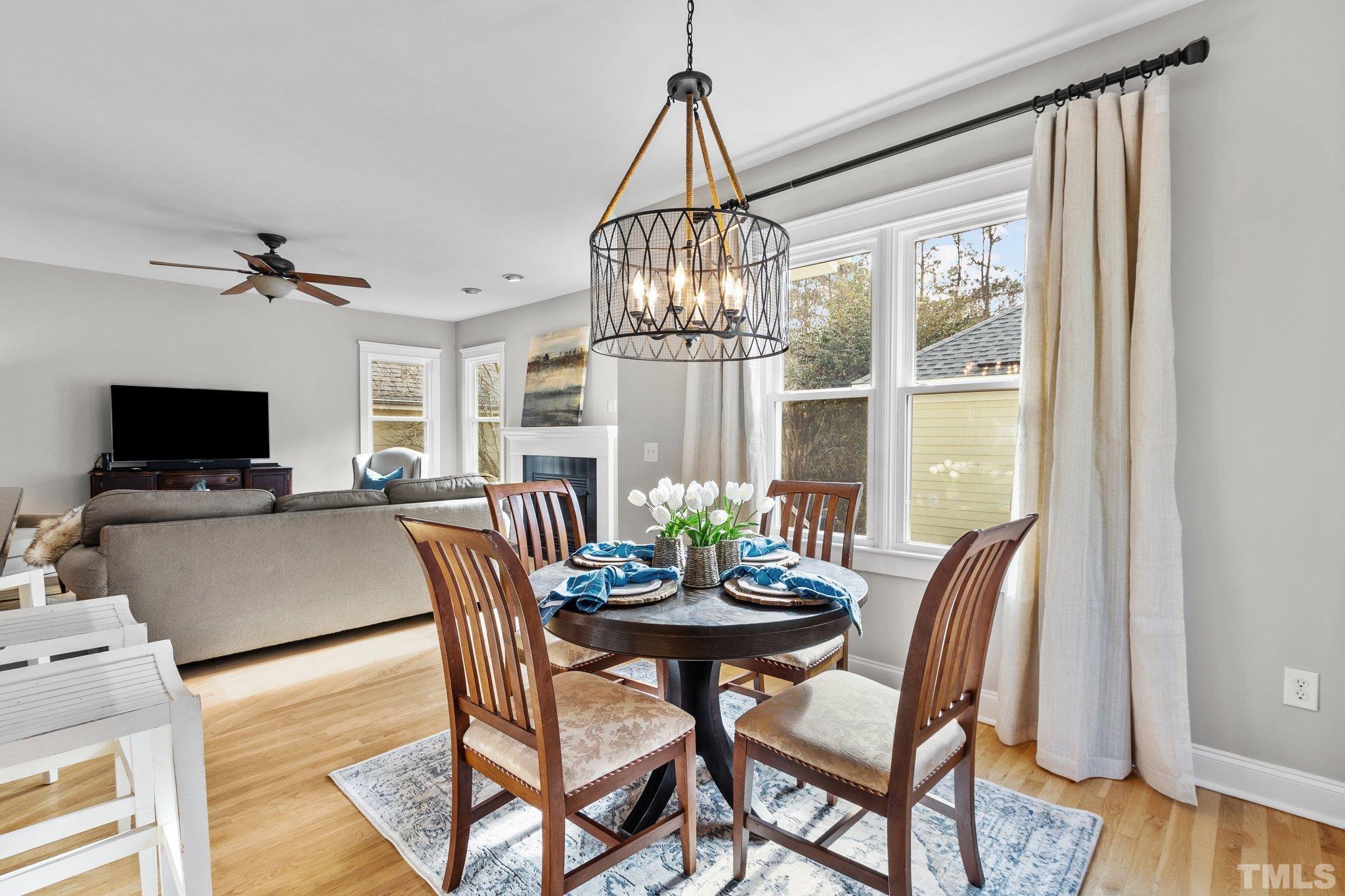 145 Kingsport Road Holly Springs, NC 27540 - Photo 12 of 42 a view of a dining room with furniture window and wooden floor