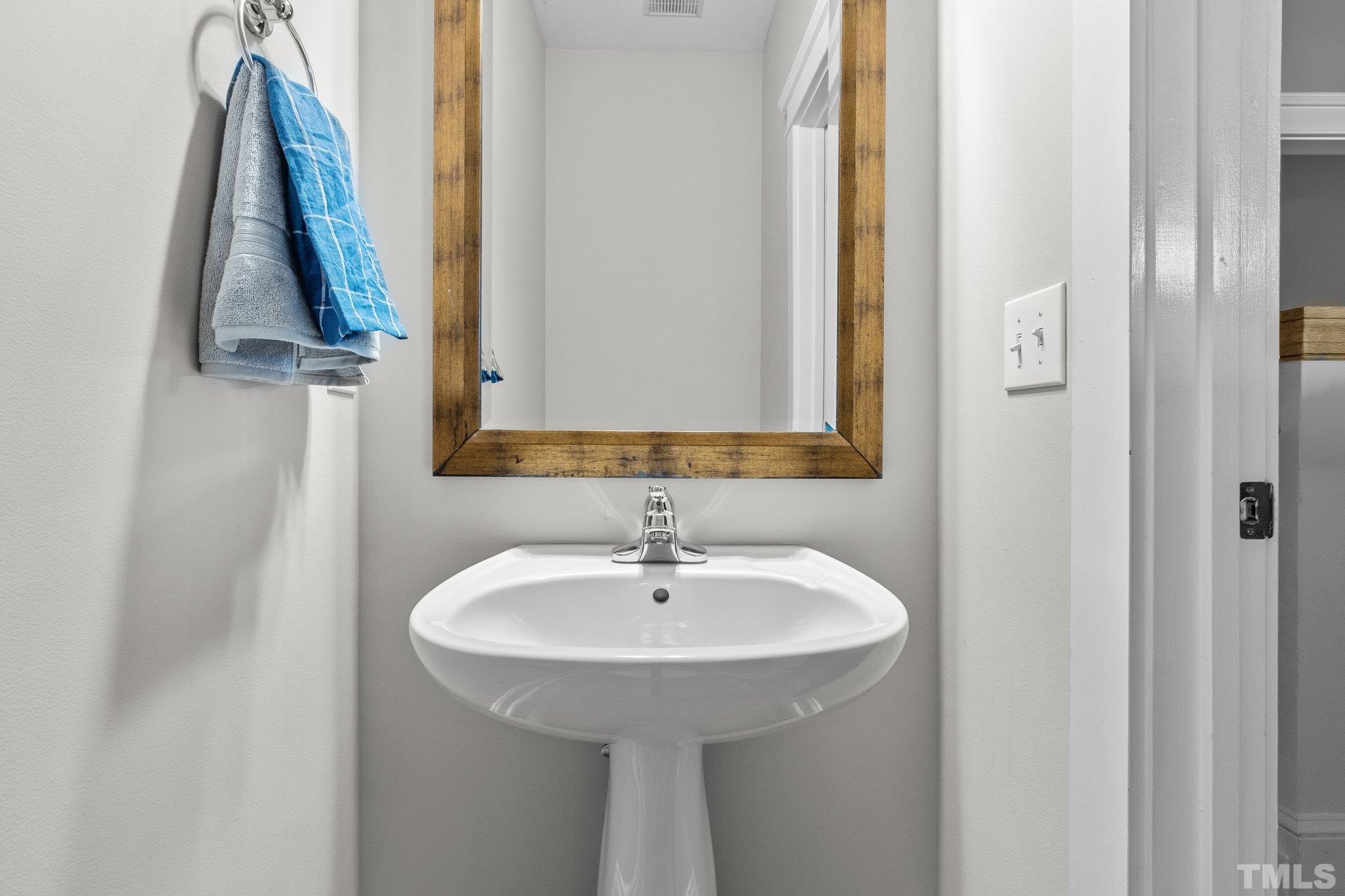 145 Kingsport Road Holly Springs, NC 27540 - Photo 18 of 42 a bathroom with a sink and a mirror