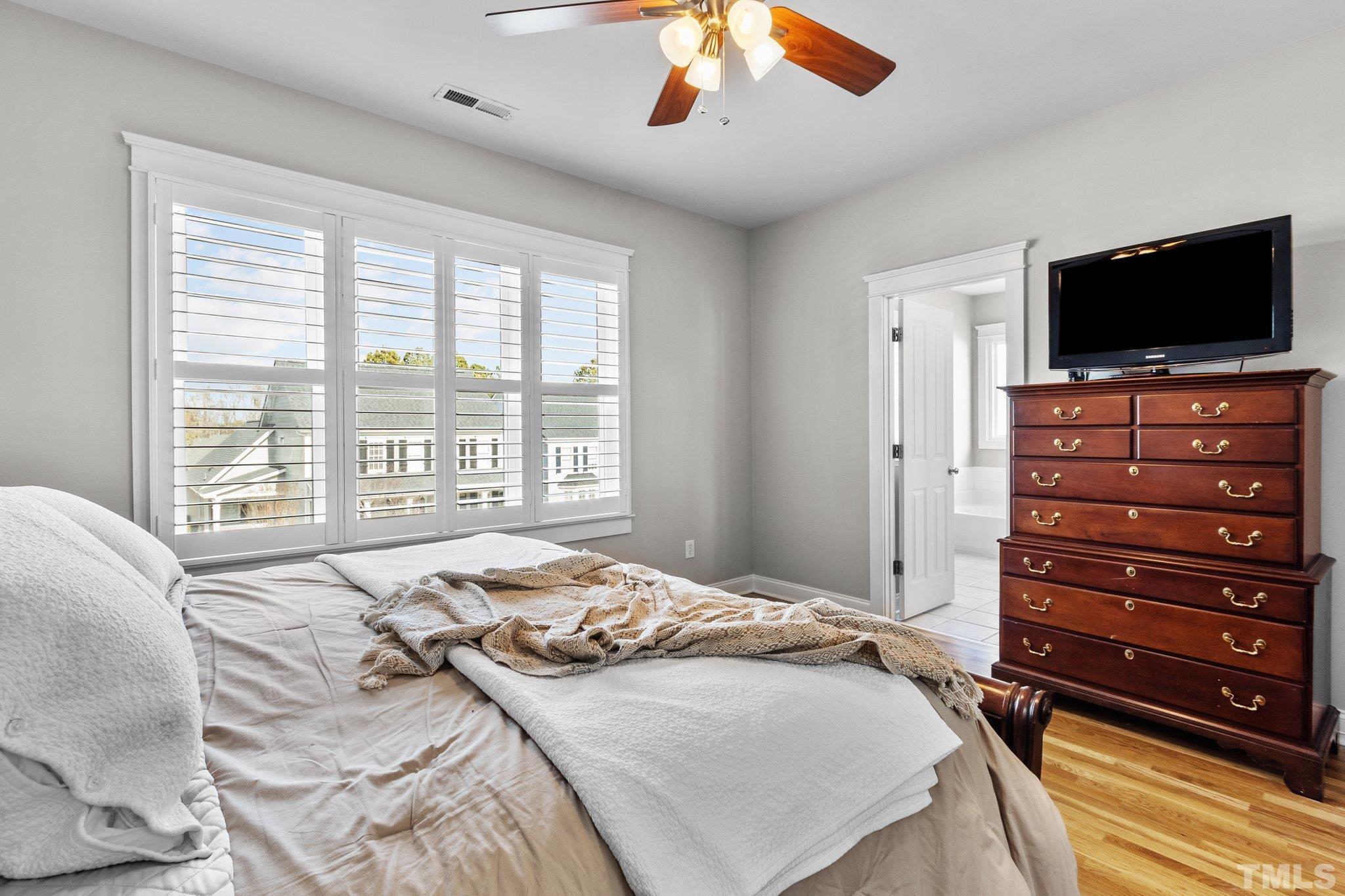 145 Kingsport Road Holly Springs, NC 27540 - Photo 19 of 42 a bedroom with a bed and a flat screen tv