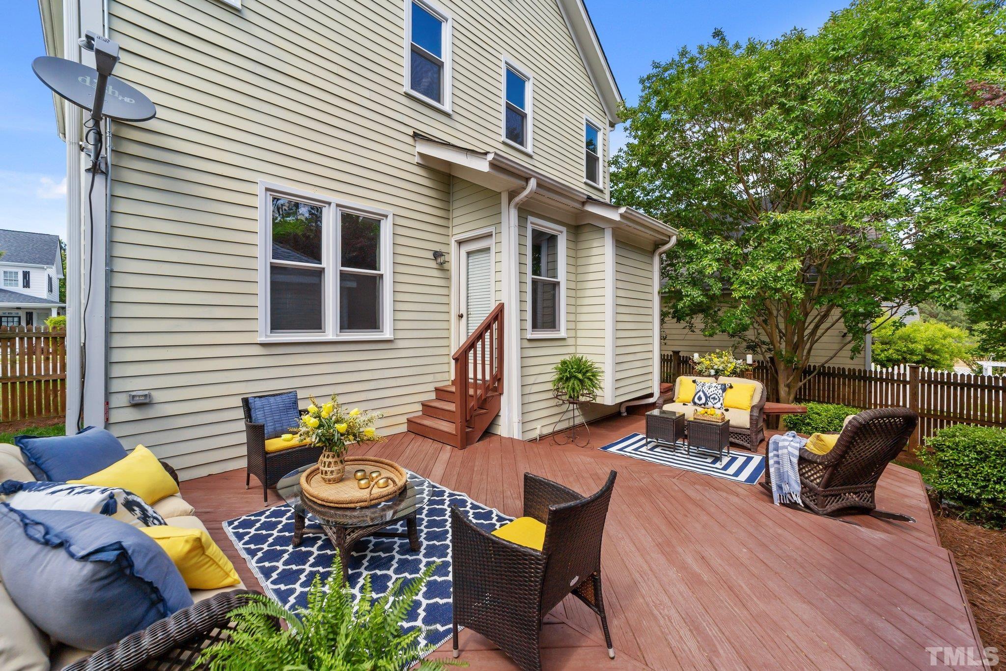 145 Kingsport Road Holly Springs, NC 27540 - Photo 25 of 42 a view of a patio with couches table and chairs and potted plants