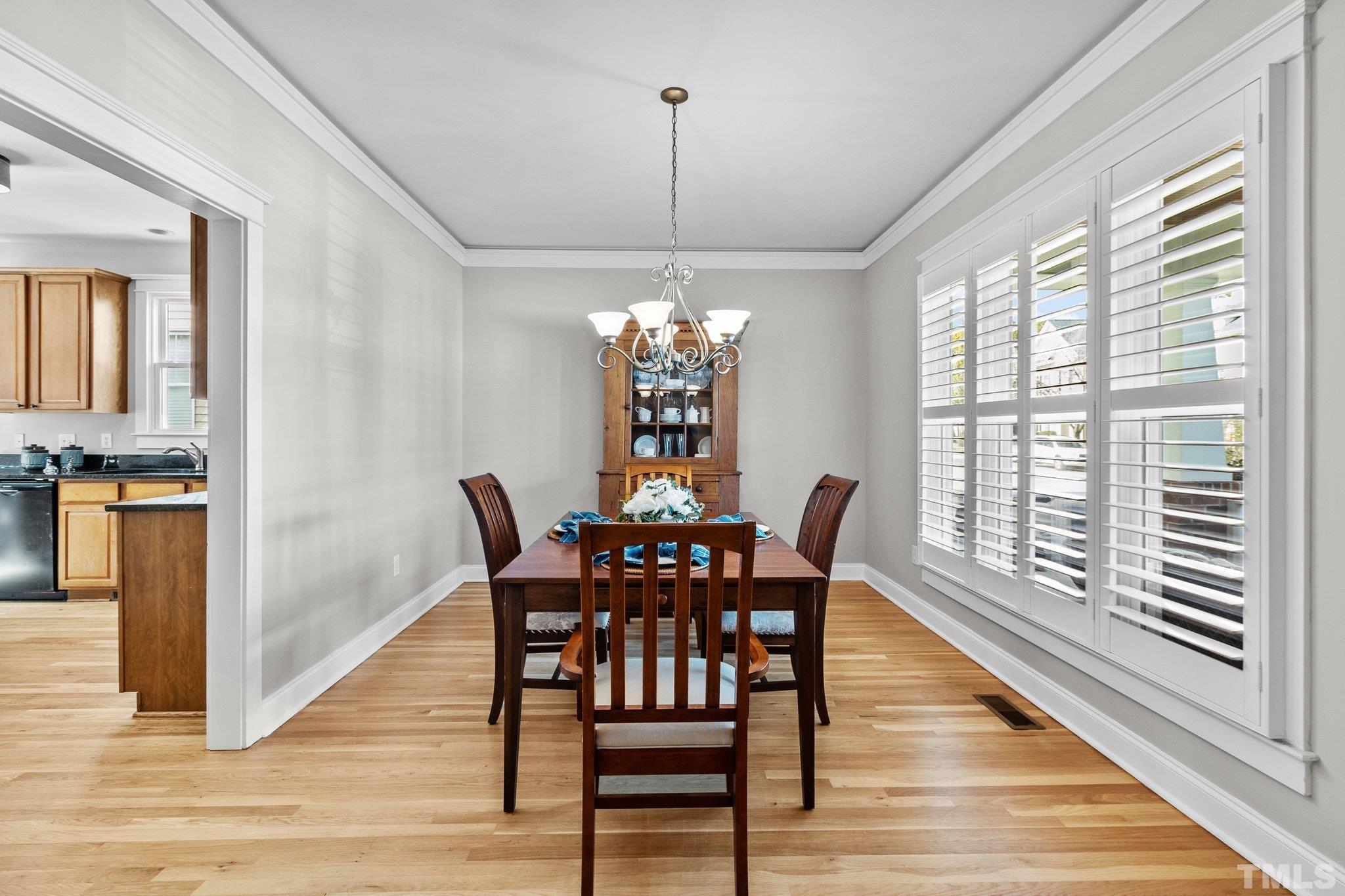 145 Kingsport Road Holly Springs, NC 27540 - Photo 8 of 42 a view of a dining room with furniture window and wooden floor