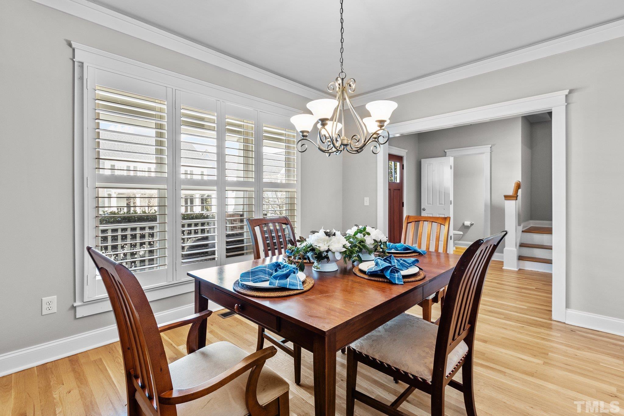 145 Kingsport Road Holly Springs, NC 27540 - Photo 9 of 42 a view of a dining room with furniture window and wooden floor