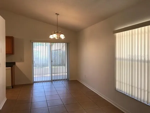 a kitchen with a refrigerator sink and cabinets