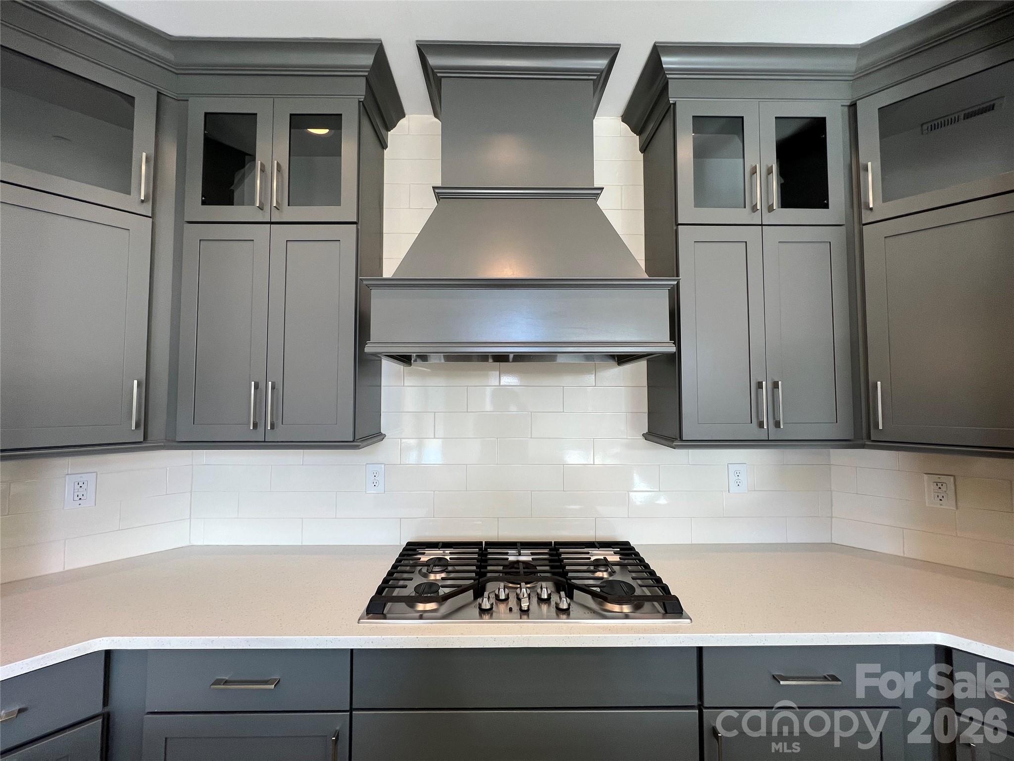 9049 Treetop Way Northwest Concord, NC 28027 - Photo 11 of 42 a kitchen with a stove and white cabinets