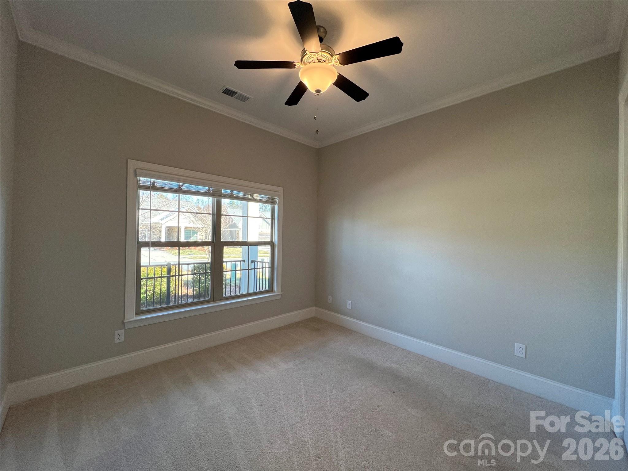 9049 Treetop Way Northwest Concord, NC 28027 - Photo 22 of 42 an empty room with a window and a fan