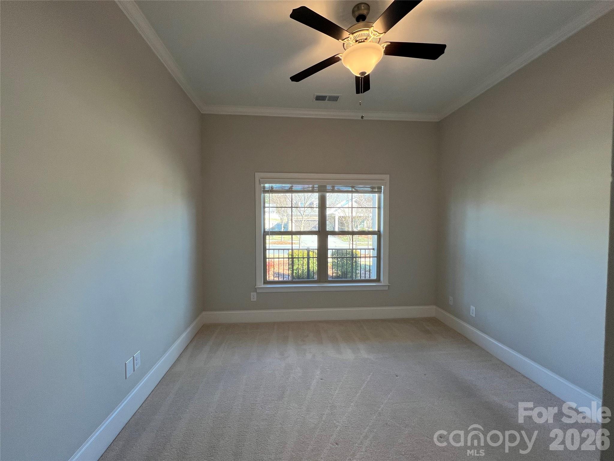 9049 Treetop Way Northwest Concord, NC 28027 - Photo 23 of 42 an empty room with a window and a fan