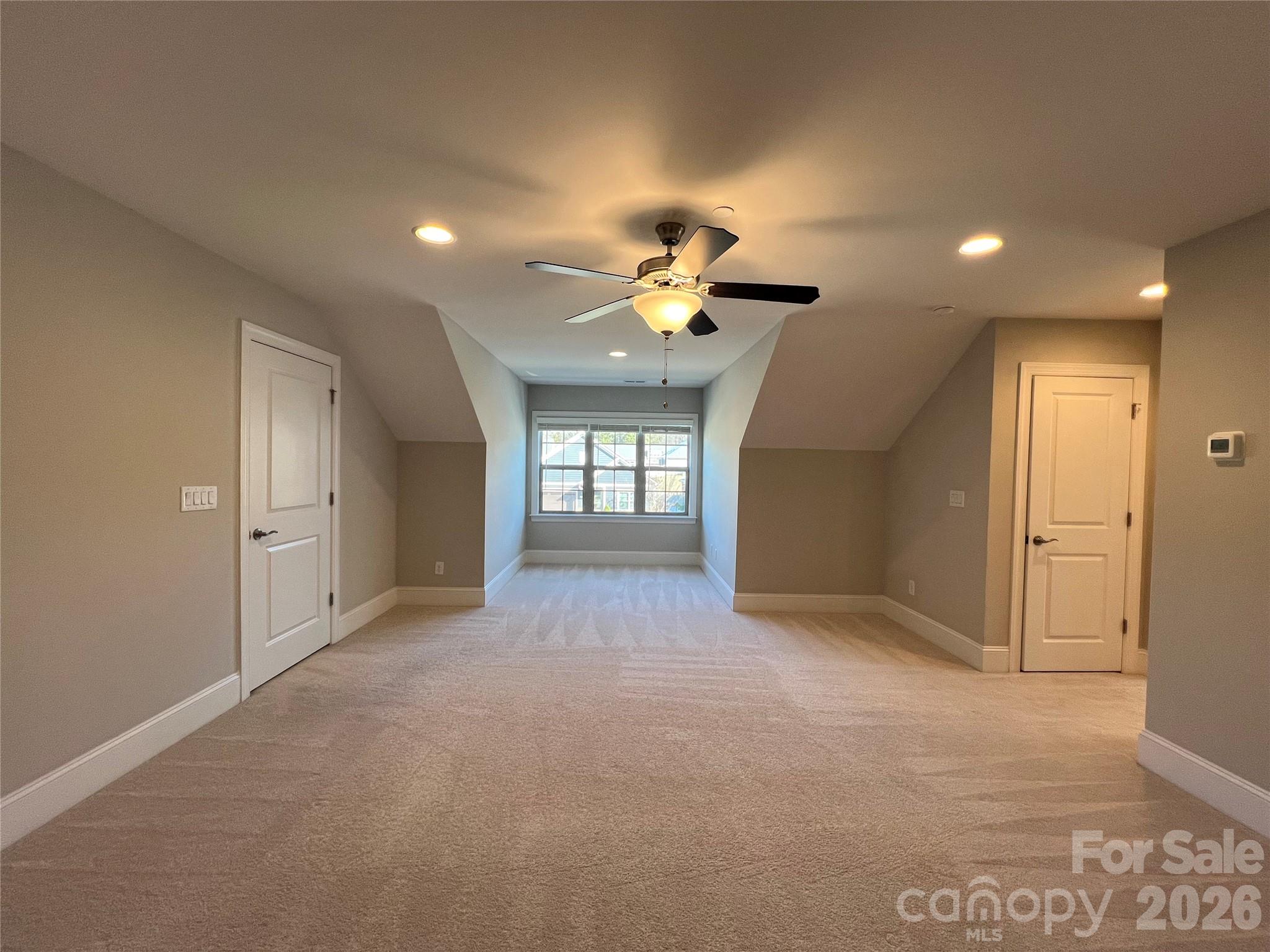 9049 Treetop Way Northwest Concord, NC 28027 - Photo 28 of 42 a view of an empty room and a ceiling fan