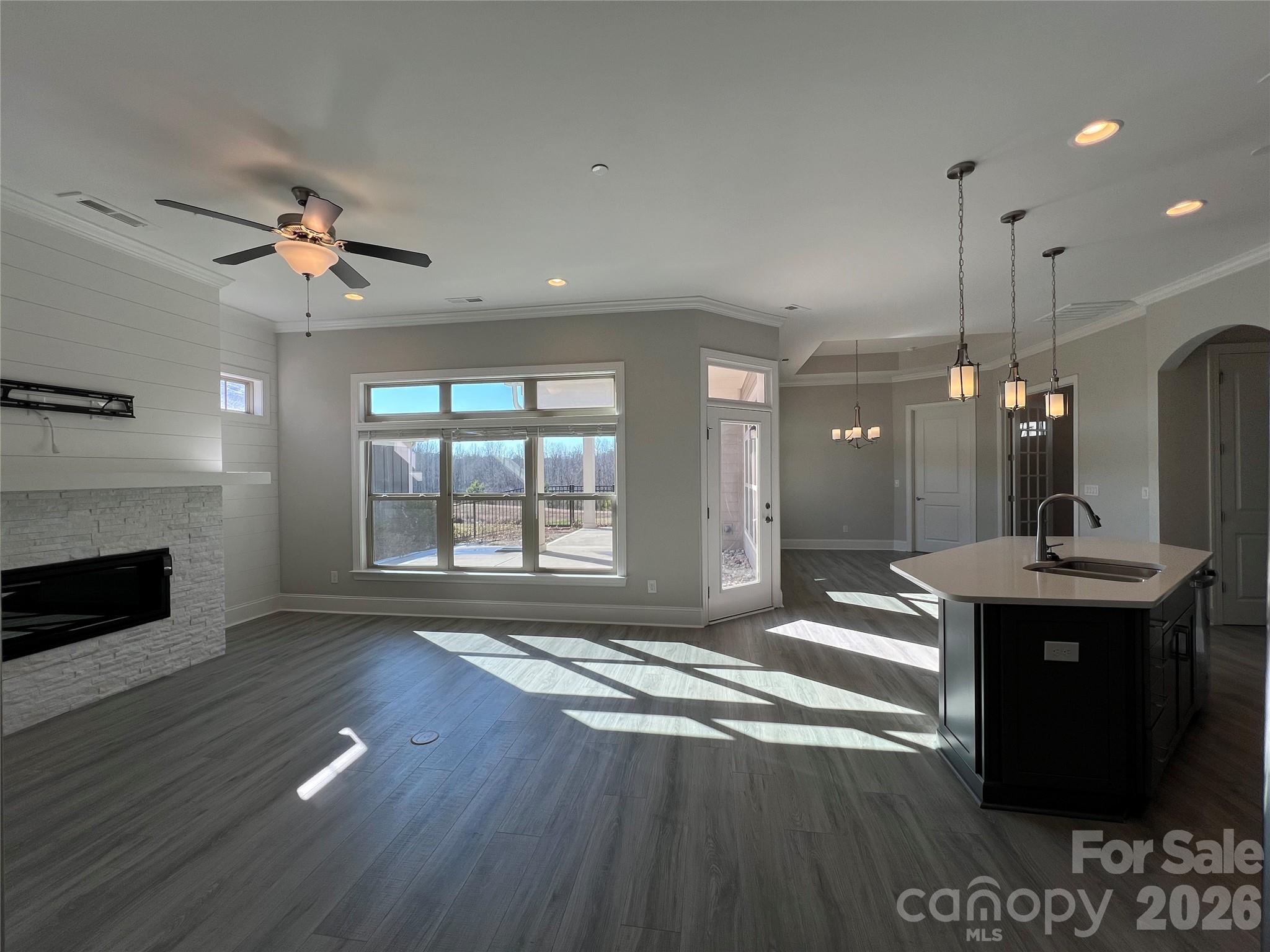9049 Treetop Way Northwest Concord, NC 28027 - Photo 6 of 42 a living room with stainless steel appliances kitchen island furniture and a fireplace